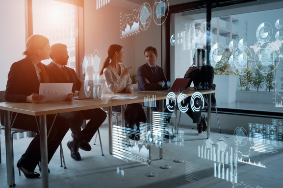 A group meets in an office conference room with conceptual analytics overlaid signifying the importance of printer management for businesses.